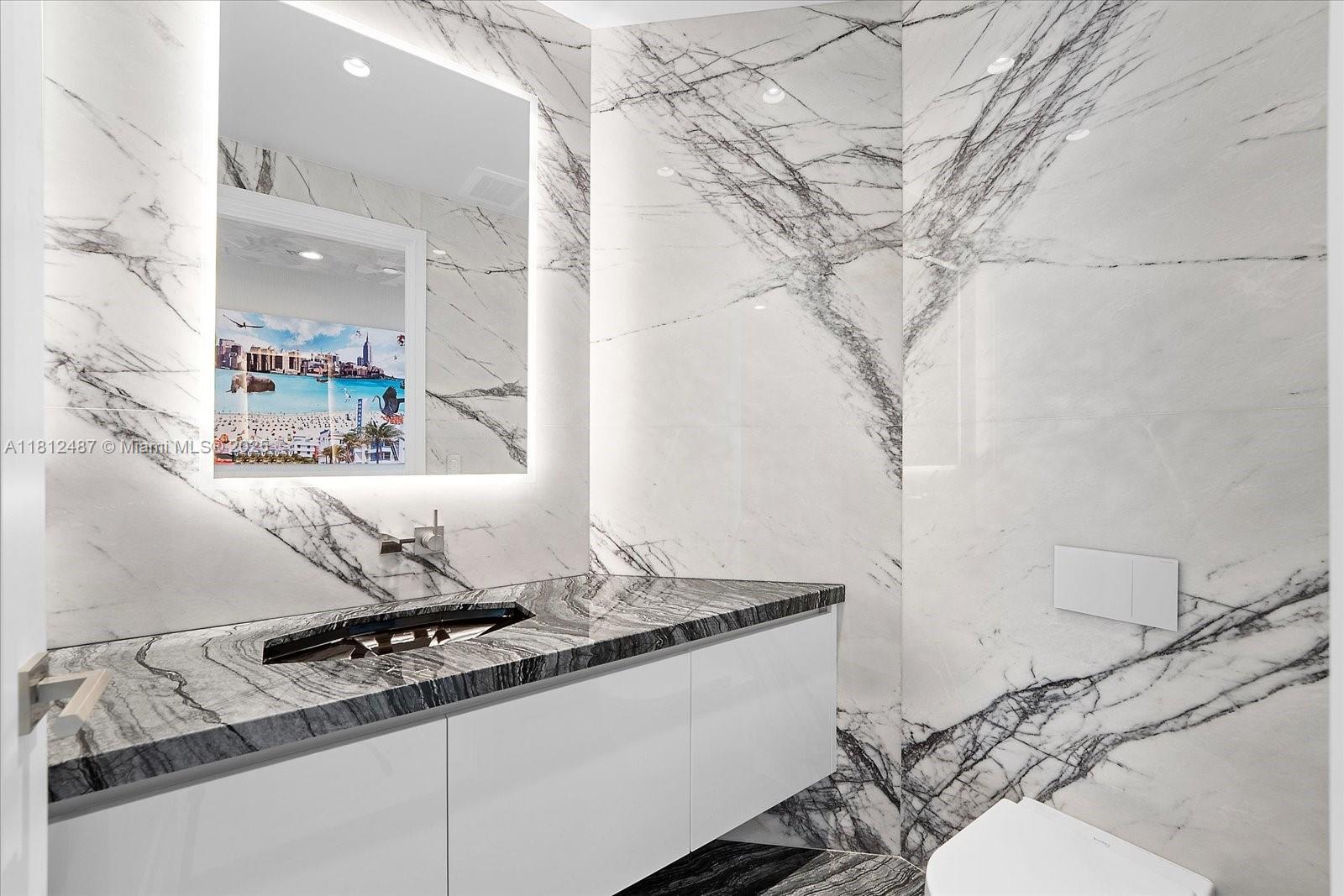 17901 Collins Avenue, Unit 3004 Sunny Isles Beach, FL 33160 - Photo 26 of 61 a bathroom with a granite countertop sink and a mirror