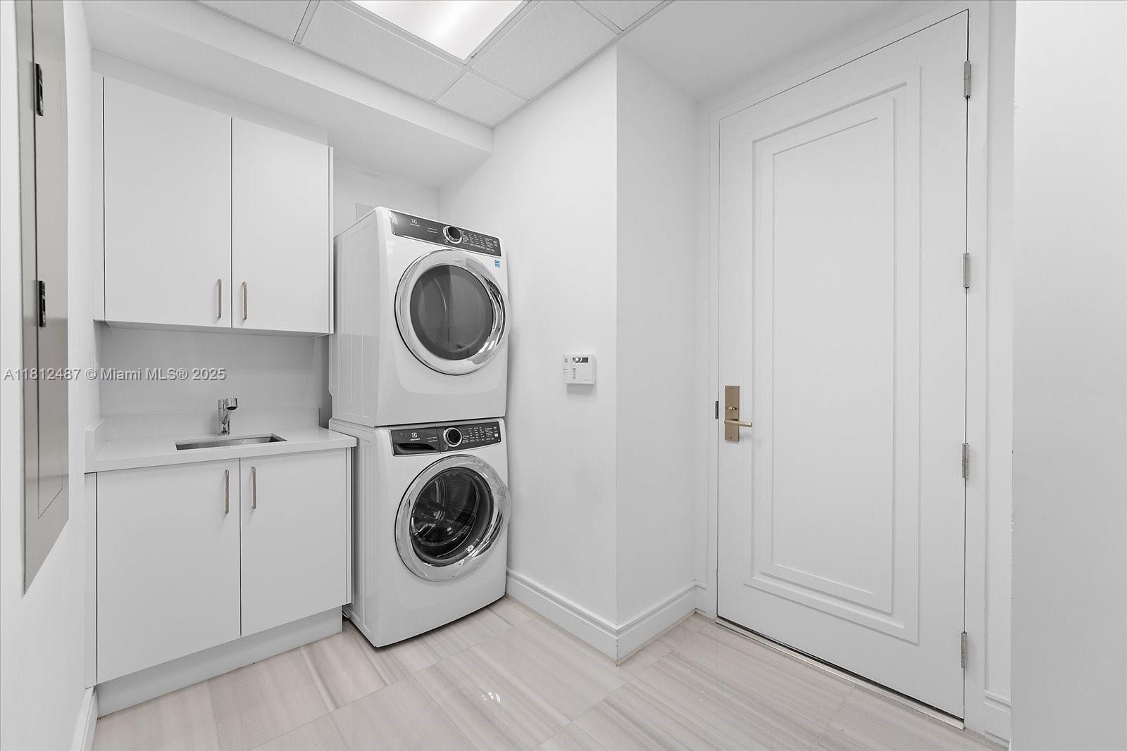 17901 Collins Avenue, Unit 3004 Sunny Isles Beach, FL 33160 - Photo 27 of 61 a utility room with sink dryer and washer