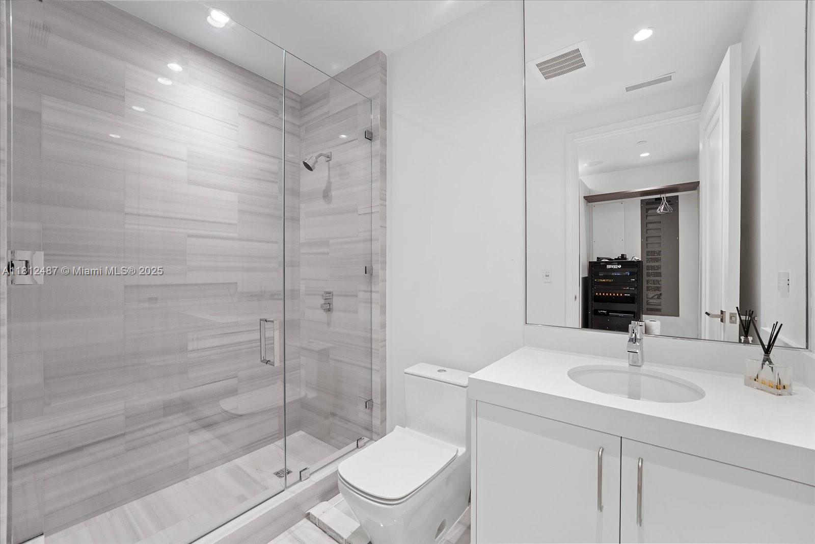 17901 Collins Avenue, Unit 3004 Sunny Isles Beach, FL 33160 - Photo 29 of 61 a bathroom with a sink a toilet and shower