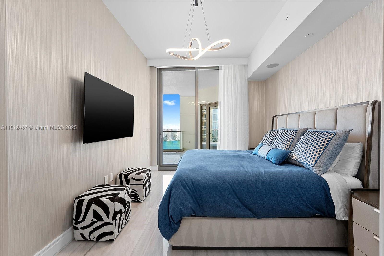 17901 Collins Avenue, Unit 3004 Sunny Isles Beach, FL 33160 - Photo 30 of 61 a bedroom with a bed and a flat screen tv