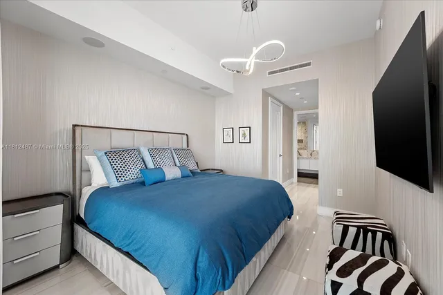 a bedroom with a bed and painting on the wall