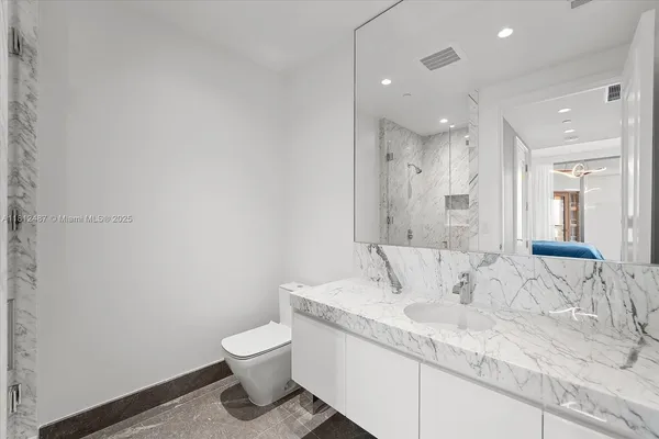a bedroom with a bed and glass door