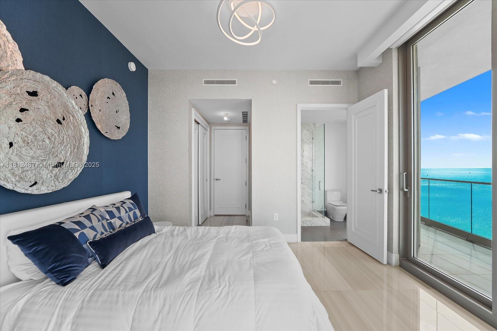 17901 Collins Avenue, Unit 3004 Sunny Isles Beach, FL 33160 - Photo 33 of 61 a bedroom with a bed and painting on the wall