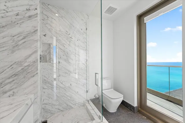 a bedroom with a large bed and a large window with outer view