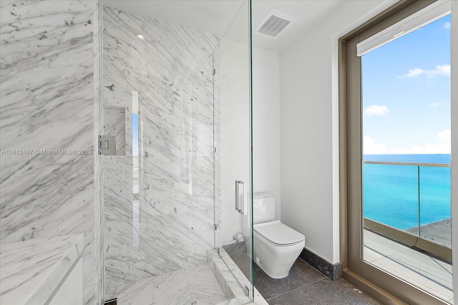 17901 Collins Avenue, Unit 3004 Sunny Isles Beach, FL 33160 - Photo 35 of 61 a bathroom with a granite countertop toilet a sink and shower