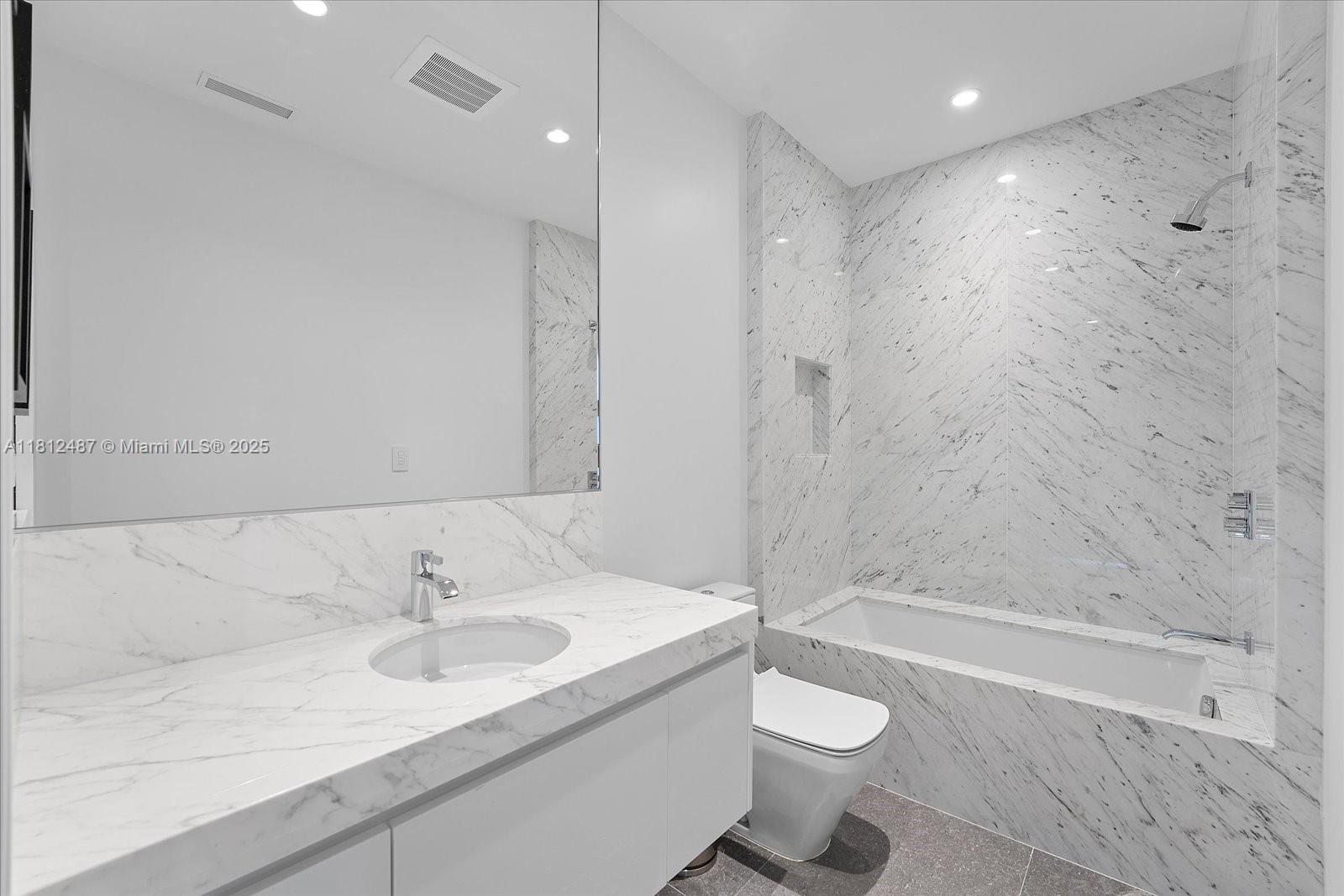 17901 Collins Avenue, Unit 3004 Sunny Isles Beach, FL 33160 - Photo 39 of 61 a bathroom with a sink a toilet and shower