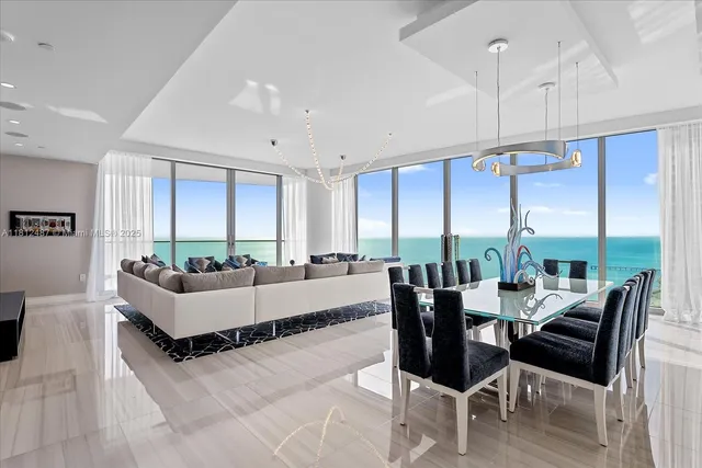 a living room with furniture and large windows