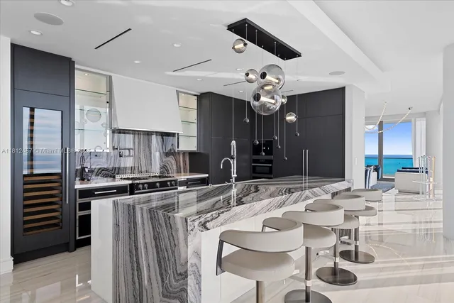 a kitchen with stainless steel appliances kitchen island granite countertop a sink and cabinets