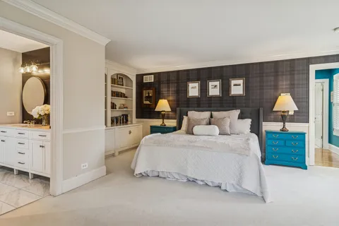 a bedroom with a large bed and a dresser