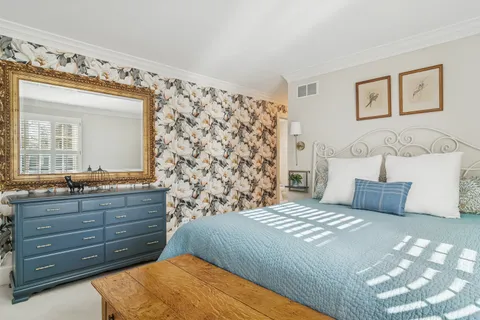 a bedroom with a bed and a dresser