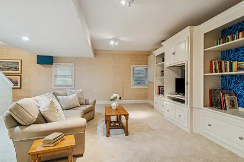 a living room with furniture and a book shelf