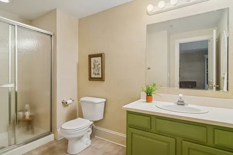 a bathroom with a toilet a sink and mirror
