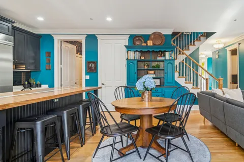 a view of a dining room with furniture and wooden floor