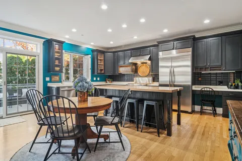 a view of a kitchen with kitchen island granite countertop a dining table and chairs