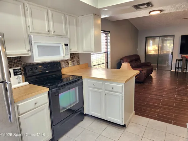 a kitchen with stainless steel appliances granite countertop a stove and a sink