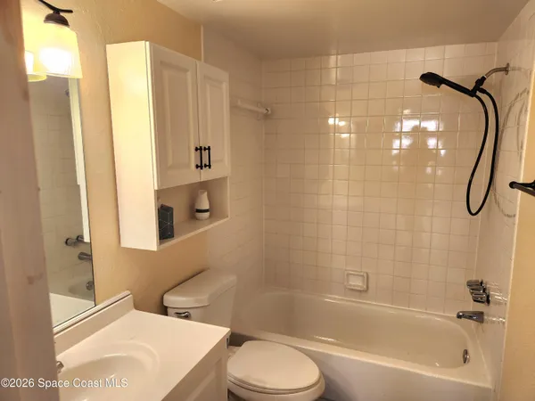 a bathroom with a toilet sink and shower