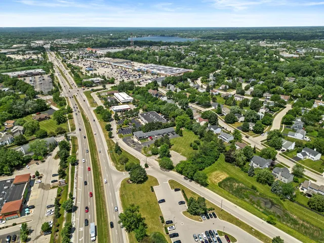 an aerial view of city lake and trees