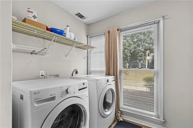 a view of a storage & utility room with dryer and washer