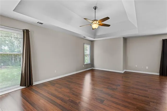 a view of a livingroom with a ceiling fan and window