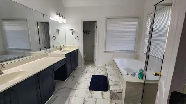 a bathroom with a double vanity sink and mirror