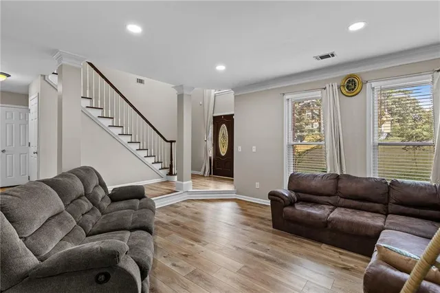 a living room with furniture and wooden floor