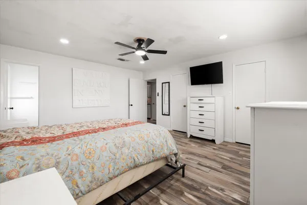 a bedroom with a bed and a flat screen tv