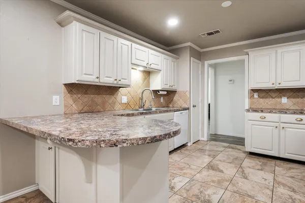 a kitchen with kitchen island granite countertop a sink cabinets and granite counter tops