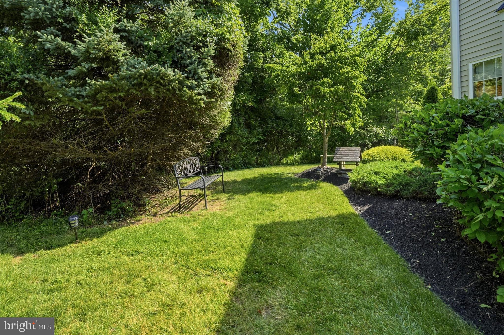 215 Flagstone Road, Unit 1 Chester Springs, PA 19425 - Photo 28 of 33 a garden with trees in the background
