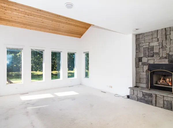 a view of a fireplace and window in a room