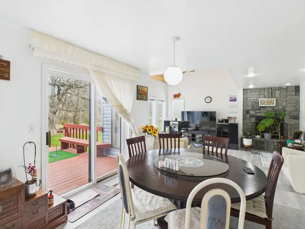 a dining room with furniture wooden floor and a rug