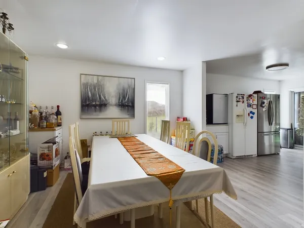 a view of a dining room with furniture and wooden floor