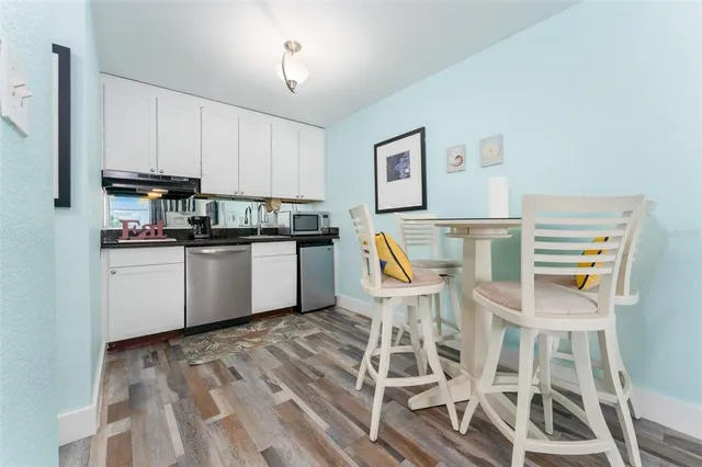 a kitchen with a sink cabinets and window
