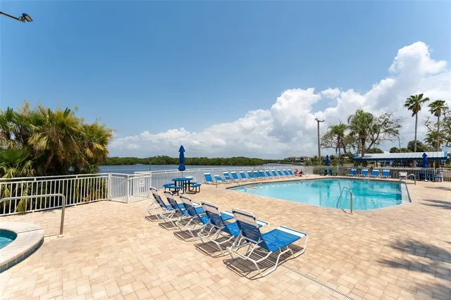 a swimming pool with outdoor seating