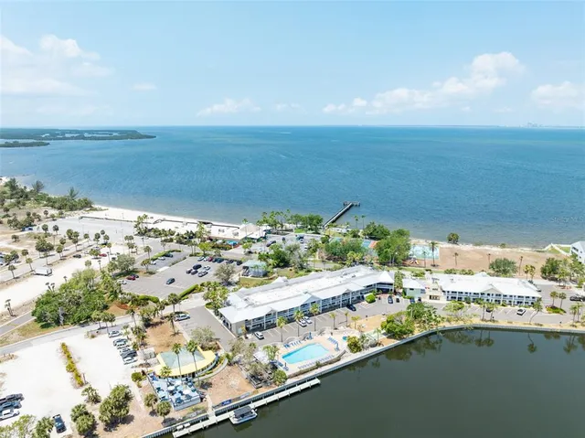 a front view of a house with a yard and mountain view in back