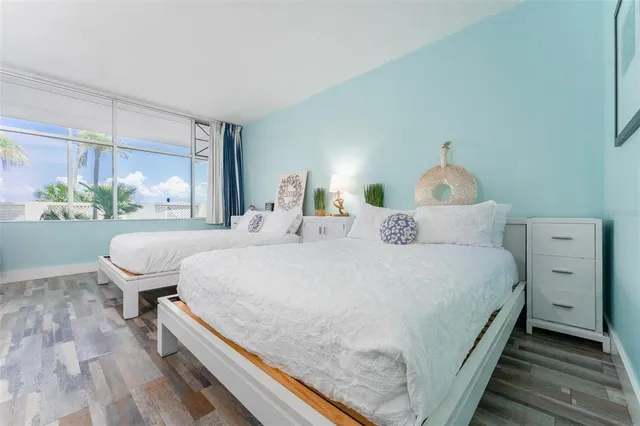 a bedroom with a large bed and a window