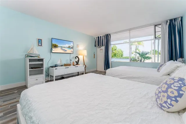 a bedroom with a bed and a painting on the wall