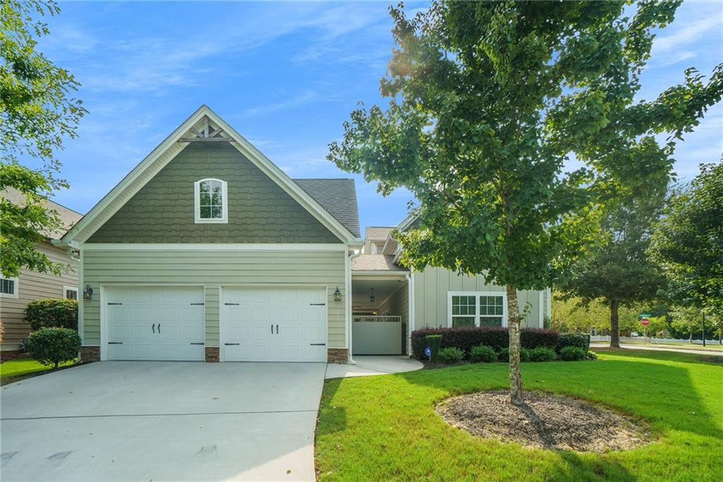 14 Vanderbilt Pointe Way Newnan, GA 30265 - Photo 1 of 1 a front view of house with a garden and trees
