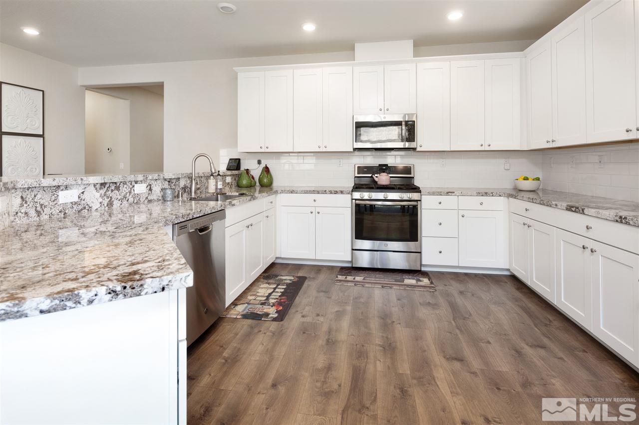 10410 Gold Mine Drive Reno, NV 89521 - Photo 5 of 24 a kitchen with a stove top oven sink and cabinets