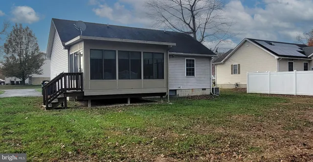 a view of backyard with a garden and deck
