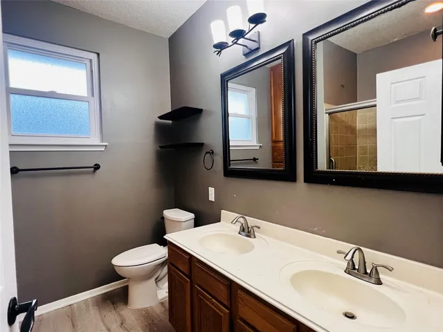 a bathroom with a toilet sink and mirror