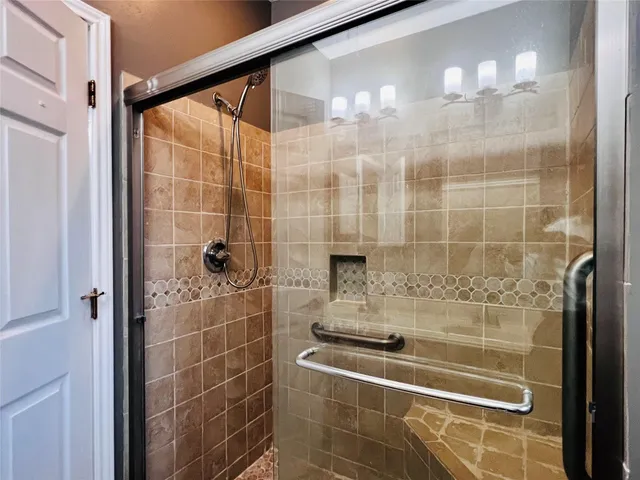 a bathroom with a shower and a sink
