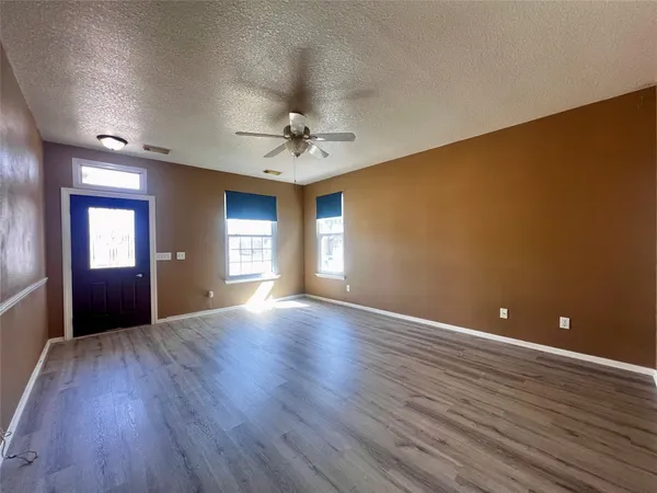 a view of room with window and wooden floor