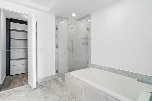 a bathroom with a bathtub and shower