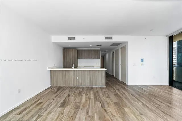 a view of a kitchen with wooden floor