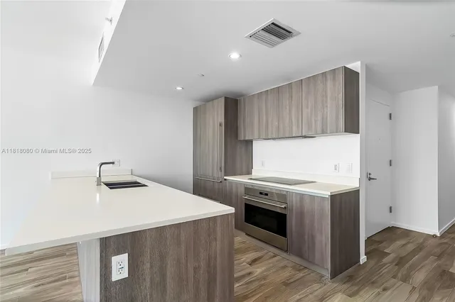 a kitchen with a sink and cabinets