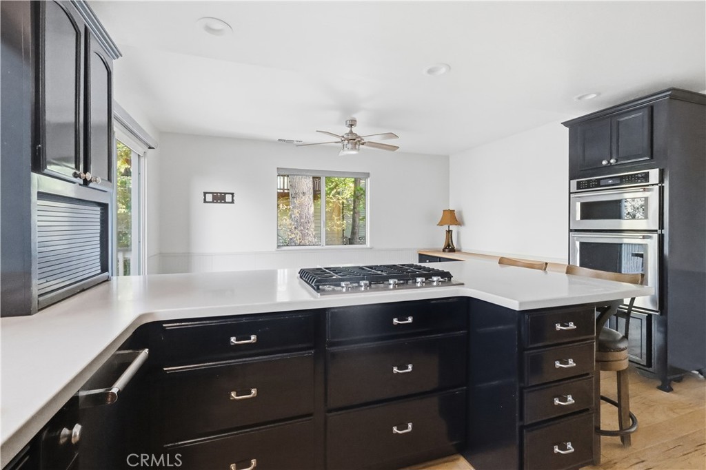 174 Golf Course Road Lake Arrowhead, CA 92391 - Photo 13 of 71 a kitchen with a sink stove and cabinets