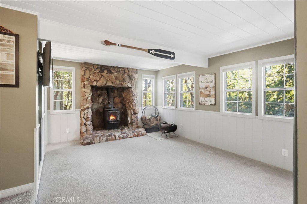 174 Golf Course Road Lake Arrowhead, CA 92391 - Photo 16 of 71 a view of an empty room with a fireplace and a window