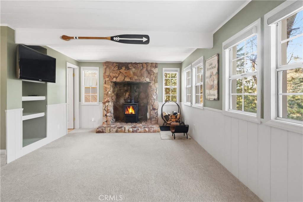 174 Golf Course Road Lake Arrowhead, CA 92391 - Photo 17 of 71 a living room with furniture a flat screen tv and a fireplace