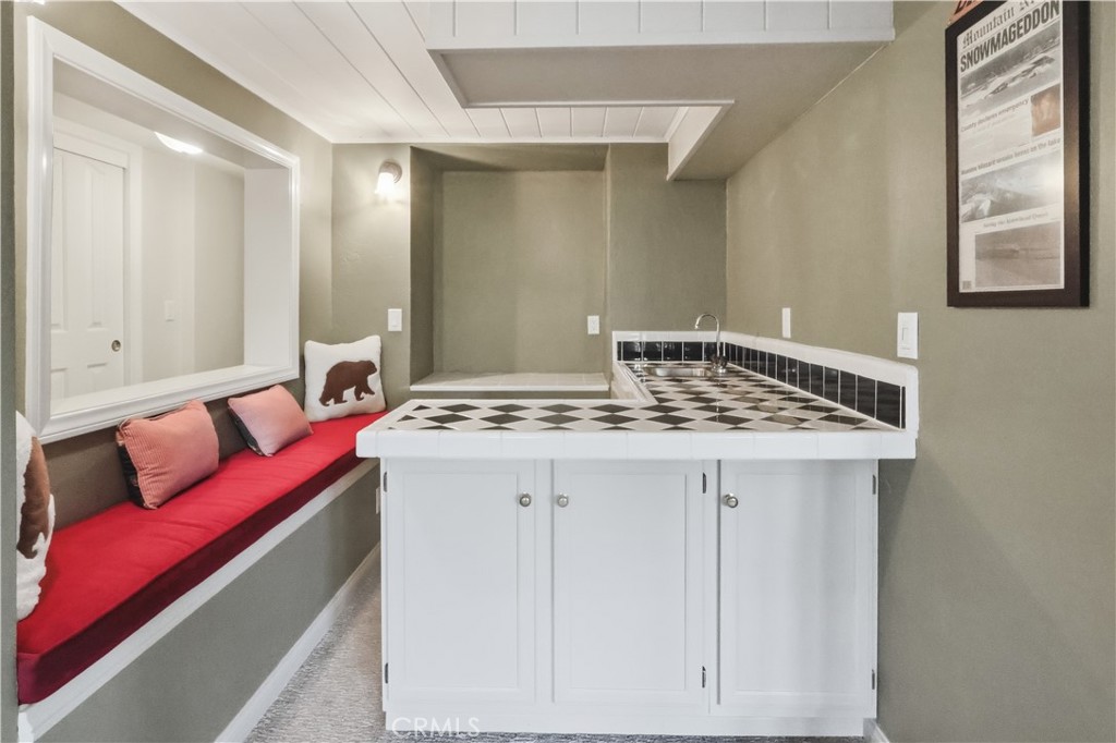 174 Golf Course Road Lake Arrowhead, CA 92391 - Photo 21 of 71 a bathroom with a granite countertop sink and a mirror