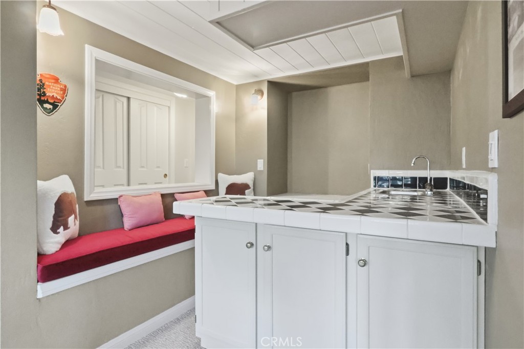 174 Golf Course Road Lake Arrowhead, CA 92391 - Photo 22 of 71 a bathroom with a granite countertop sink and a mirror